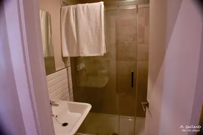 a bathroom with a shower and a sink at Hostal Playa Candor in Rota