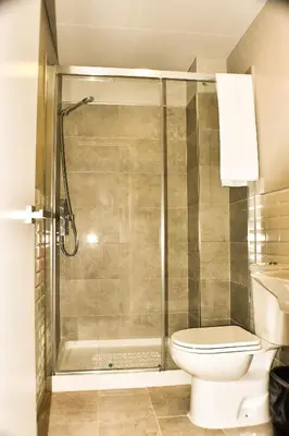 a bathroom with a shower and a toilet at Hostal Playa Candor in Rota