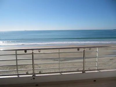 a view of the beach from a balcony at Life Apartments Fuentebravía in El Puerto de Santa María