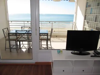 a computer on a desk with a view of the ocean at Life Apartments Fuentebravía in El Puerto de Santa María