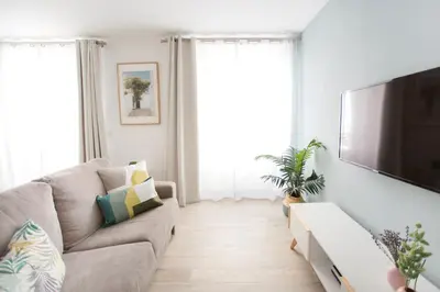a living room with a couch and a flat screen tv at Nueva ALMUDENA Apartment by Cadiz4Rentals in Cádiz