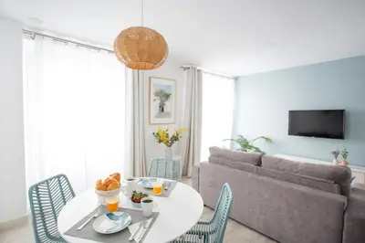a living room with a table and a couch at Nueva ALMUDENA Apartment by Cadiz4Rentals in Cádiz
