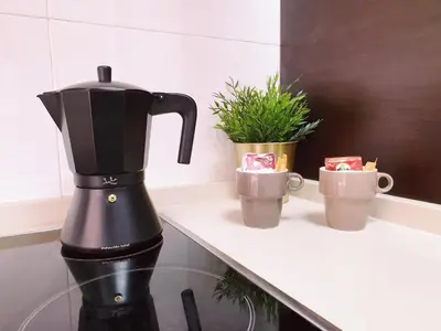 a black coffee maker on a counter with two cups at Sherryflat Moneo - Parking in Jerez de la Frontera