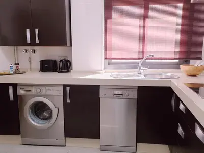a kitchen with a washing machine and a sink at Sherryflat Moneo - Parking in Jerez de la Frontera