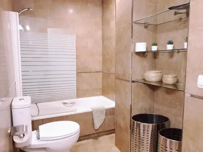 a bathroom with a toilet and a sink and a shower at Sherryflat Moneo - Parking in Jerez de la Frontera