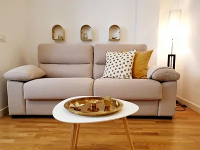 a living room with a couch and a table at Sherryflat Moneo - Parking in Jerez de la Frontera