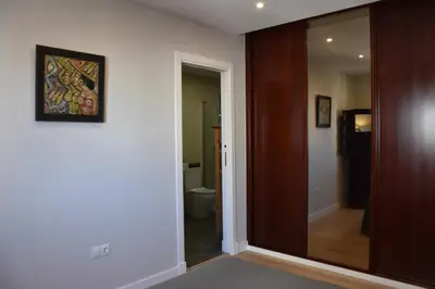 a hallway with a sliding glass door to a bathroom at Sweet Velázquez Apto. zona Playa Victoria in Cádiz