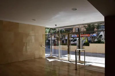 a lobby with doors open to a building at Sweet Velázquez Apto. zona Playa Victoria in Cádiz