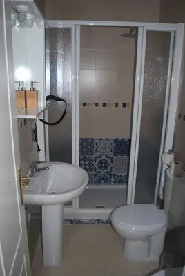 a bathroom with a sink and a toilet and a shower at Apartamentos Costa de la Luz playa in Rota