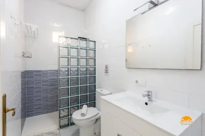 a bathroom with a toilet and a sink and a mirror at Mar de Cadiz by Cadiz Time in Cádiz