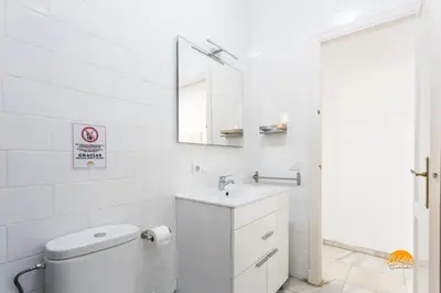 a white bathroom with a sink and a mirror at Mar de Cadiz by Cadiz Time in Cádiz