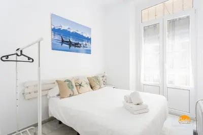 a white bedroom with a bed and a window at Mar de Cadiz by Cadiz Time in Cádiz