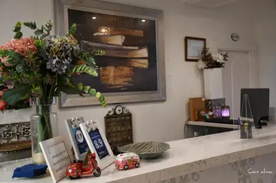 a counter with a vase of flowers and a vase of flowers at Hostal El Puerto Boutique in Chipiona
