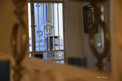 a reflection of a door in a mirror at Hostal El Puerto Boutique in Chipiona