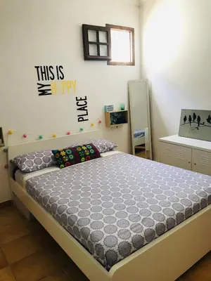 a bedroom with a bed in a room at Preciosa casa baja con aire acondicionado in Sanlúcar de Barrameda