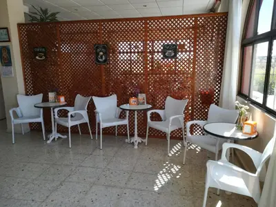a table with a vase of flowers on top at Vivienda Rural Alcazaba in Chipiona