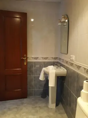 a bathroom with a sink and a mirror at Vivienda Rural Alcazaba in Chipiona