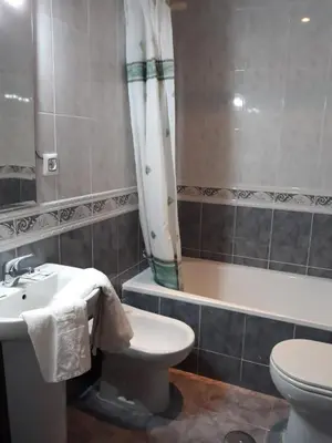 a bathroom with a sink and a toilet and a tub at Vivienda Rural Alcazaba in Chipiona