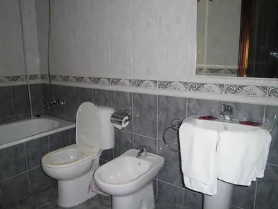 a bathroom with a sink and a toilet at Vivienda Rural Alcazaba in Chipiona