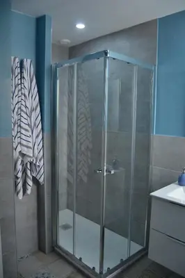 a shower with a glass door in a bathroom at Beautiful Central Cadiz in Cádiz