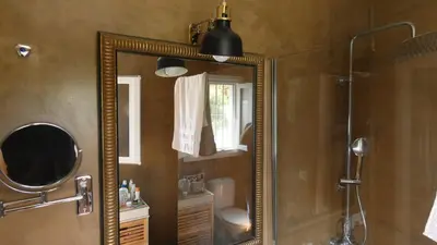 a bathroom with a large mirror and a shower at Villa Lolo de design con Piscina, Jardin y Parking exclusivo in Chiclana de la Frontera