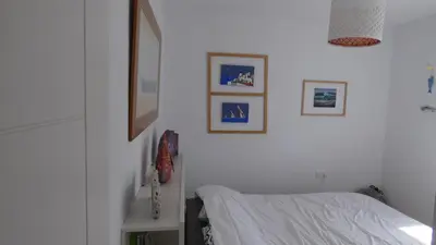 a bedroom with a bed and pictures on the wall at Villa Lolo de design con Piscina, Jardin y Parking exclusivo in Chiclana de la Frontera