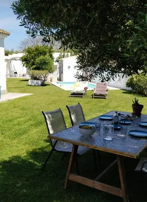 a table with a bowl of food on it in a yard at Villa Lolo de design con Piscina, Jardin y Parking exclusivo in Chiclana de la Frontera