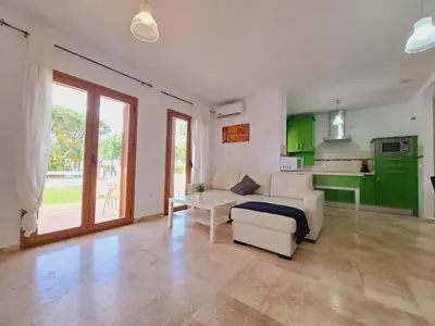 a living room with a couch and a table at Apartamentos Turísticos La Carrajolilla in Chiclana de la Frontera