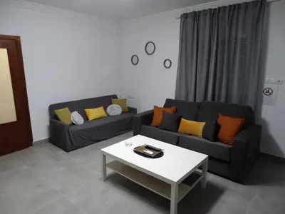 a living room with a fireplace and a tv at Casasjerezanas VistaFlor in Jerez de la Frontera
