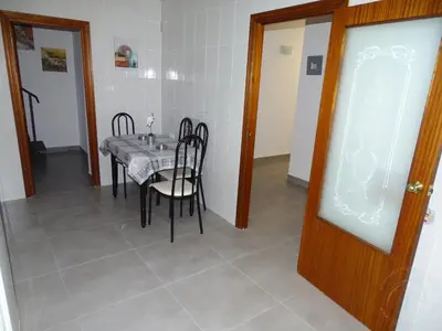 a kitchen with white cabinets and a refrigerator at Casasjerezanas VistaFlor in Jerez de la Frontera