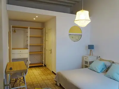 a bedroom with a bed and a table and a desk at Veedor 12 in Cádiz