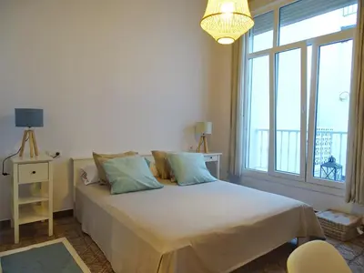 a bedroom with a bed with a large window at Veedor 12 in Cádiz