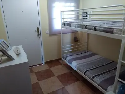 a bunk bed room with two bunk beds and a door at Dunas villa in El Puerto de Santa María