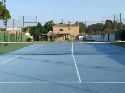 a tennis court with a net on top of it at Dunas villa in El Puerto de Santa María