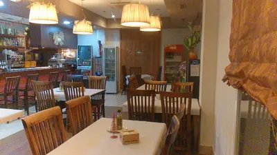a restaurant with tables and chairs and a bar at Hotel Las Canteras de Puerto Real in Puerto Real