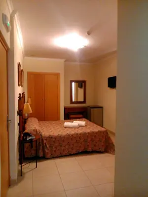 a bedroom with a bed with two towels on it at Hotel Las Canteras de Puerto Real in Puerto Real