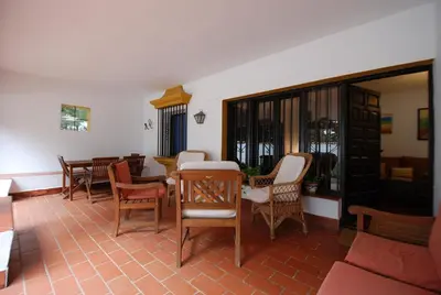 a living room with a table and chairs at Oasis en la playa in Chiclana de la Frontera