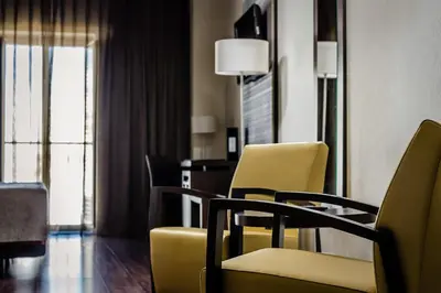 a room with chairs and a table and a window at Eurostars Asta Regia Jerez in Jerez de la Frontera