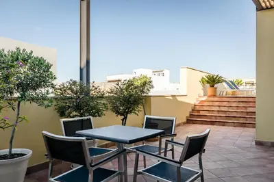 a patio with a table and chairs on a balcony at Eurostars Asta Regia Jerez in Jerez de la Frontera