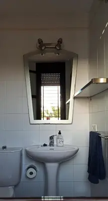 a bathroom with a sink and a mirror and a toilet at Atardeceres Sureños - Gran Terraza - Parking in Jerez de la Frontera