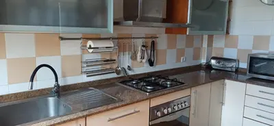 a kitchen with a sink and a stove top oven at Atardeceres Sureños - Gran Terraza - Parking in Jerez de la Frontera