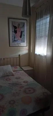 a bedroom with a bed and a picture on the wall at Atardeceres Sureños - Gran Terraza - Parking in Jerez de la Frontera