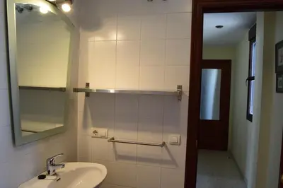 a bathroom with a sink and a mirror at Atardeceres Sureños - Gran Terraza - Parking in Jerez de la Frontera