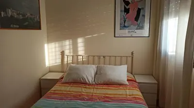 a bed with two pillows on it in a bedroom at Atardeceres Sureños - Gran Terraza - Parking in Jerez de la Frontera