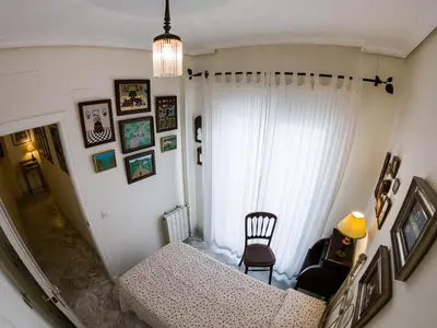 a room with a staircase with a couch and a chair at La Terraza del Drago in Cádiz