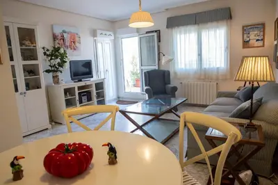 a living room with a table with a tomato on it at La Terraza del Drago in Cádiz