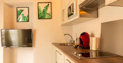 a kitchen with a sink and a red appliance at CDZ - Poniente in Cádiz