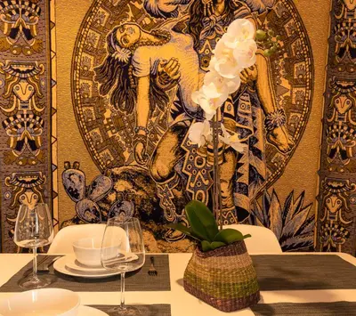 a table with two glasses and a vase with white flowers at CDZ - Poniente in Cádiz