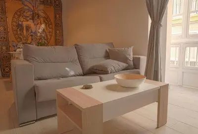 a living room with a couch and a table at CDZ - Poniente in Cádiz