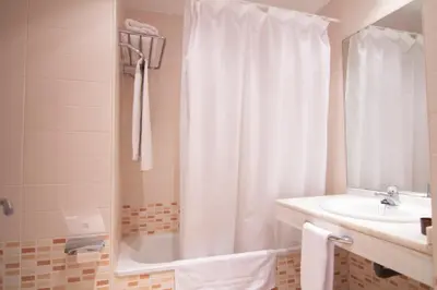 a bathroom with a tub and a sink and a shower at Apartamento Racimo El Puerto de Santa Maria in El Puerto de Santa María